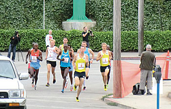 Starting group rounds the first corner as they move away from the Santa Cruz Beach Boardwalk WtW_RoundingfirstCorner Wharf to Wharf Times Publishing Group Inc tpgonlinedaily.com