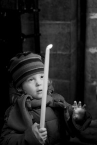 Girl with candle in church