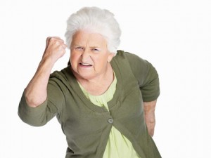 Senior woman in angry gesture isolated against white