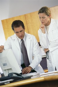 Doctors Studying Data on Computer
