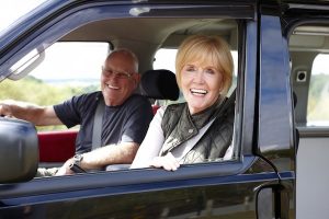 Portrait of a happy senior couple enjoying car ride husband in drivers seat - Horizantal composition