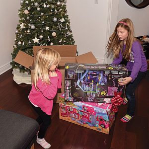 Adopt-A-Family_Kids-opening-presents Adopt-A-Family Times Publishing Group Inc tpgonlinedaily.com