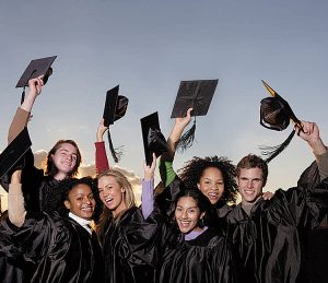 Graduates Lifting Mortarboards --- Image by � Royalty-Free/Corbis